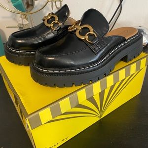 Black mules with gold hardware